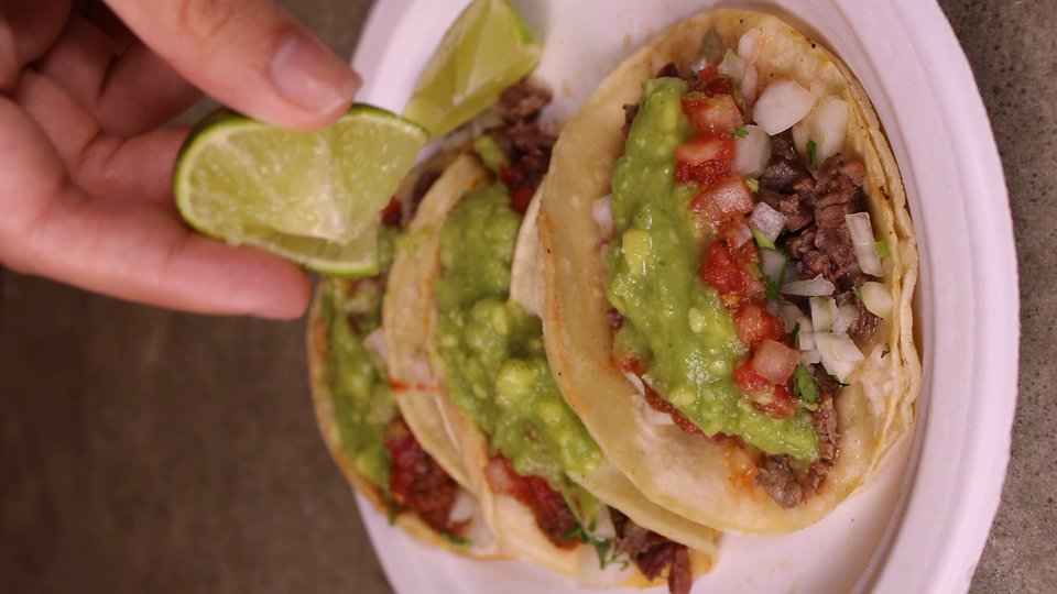 Close-up of street tacos on a table.