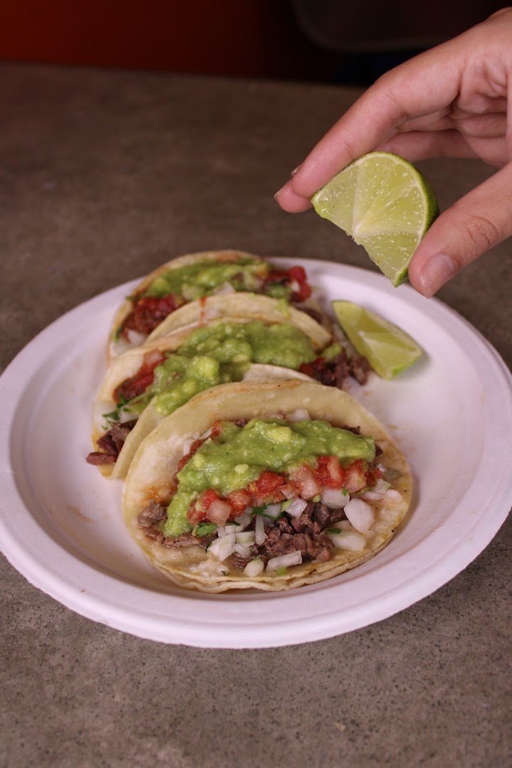 Colorful tacos on a restaurant plate.
